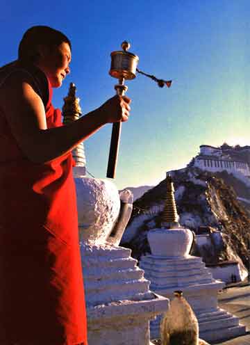 
Nun Spins Prayer Wheel As Sun Rises Over Potala Palace In Lhasa - Himalaya The Secret Of The Golden Tara By Dieter Glogowski book
